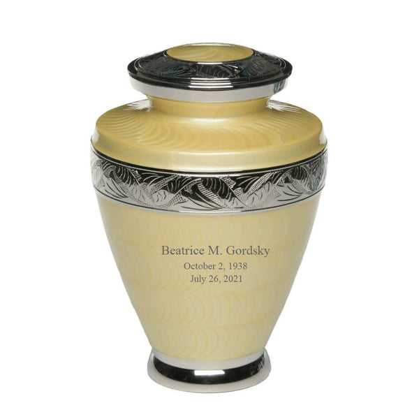 Yellow urn for ashes with nickel leaves engraved on bands across urn